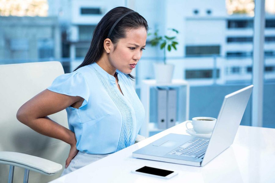 Woman at work with back pain.